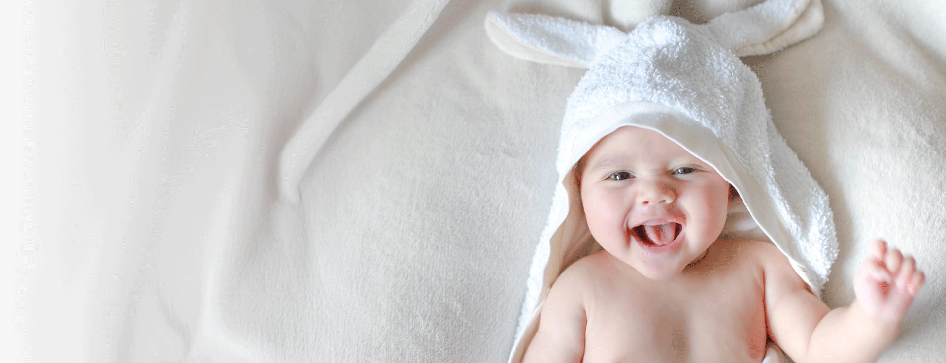 baby in a towel smiling